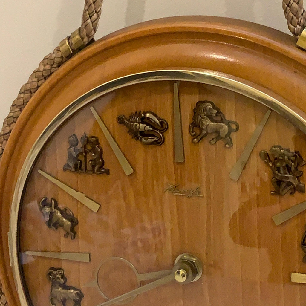 Kienzle Zodiac Wall Clock: Rope Hung Wooden Case, Brass Symbols, Mid Century 1960s Quartz