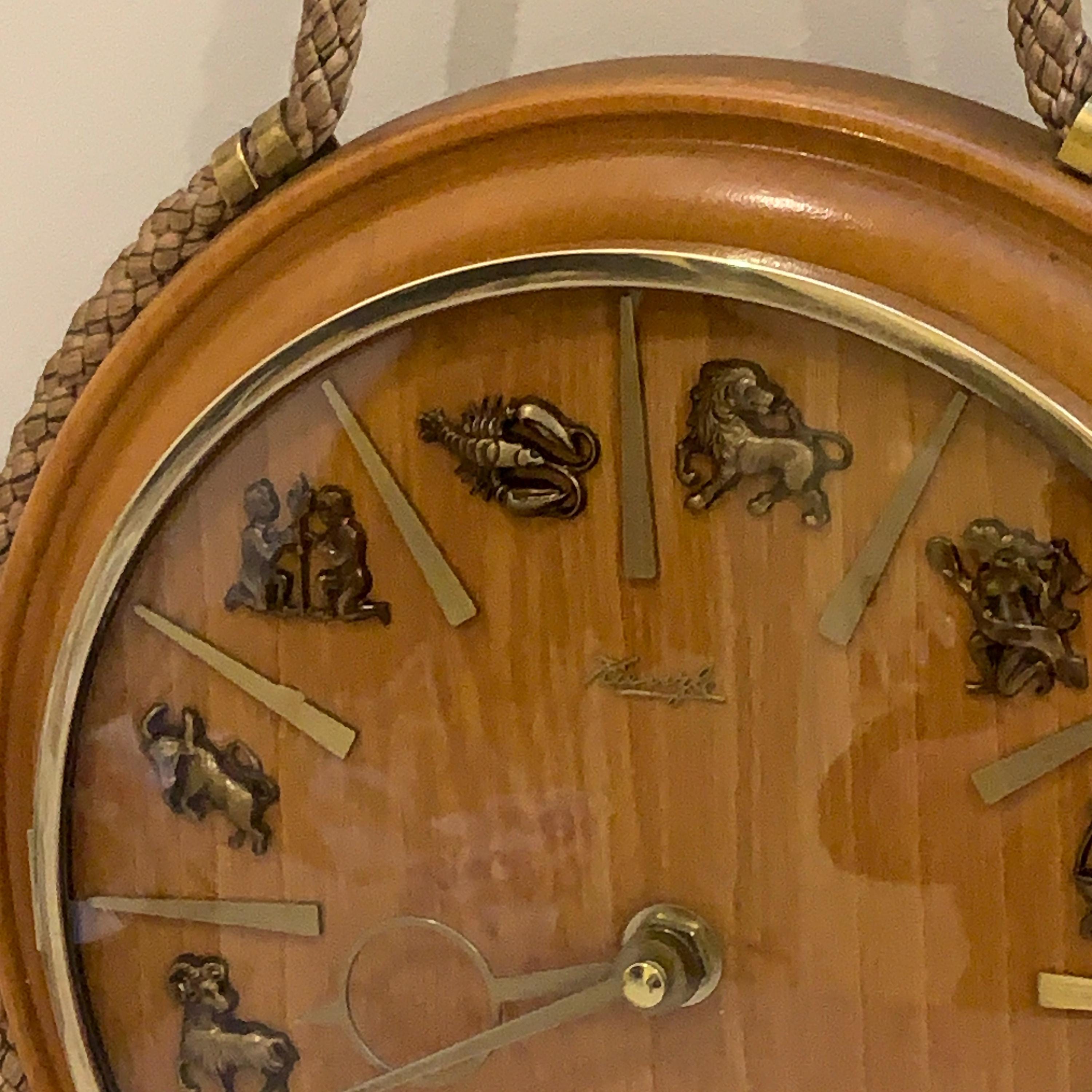 Kienzle Zodiac Wall Clock: Rope Hung Wooden Case, Brass Symbols, Mid Century 1960s Quartz