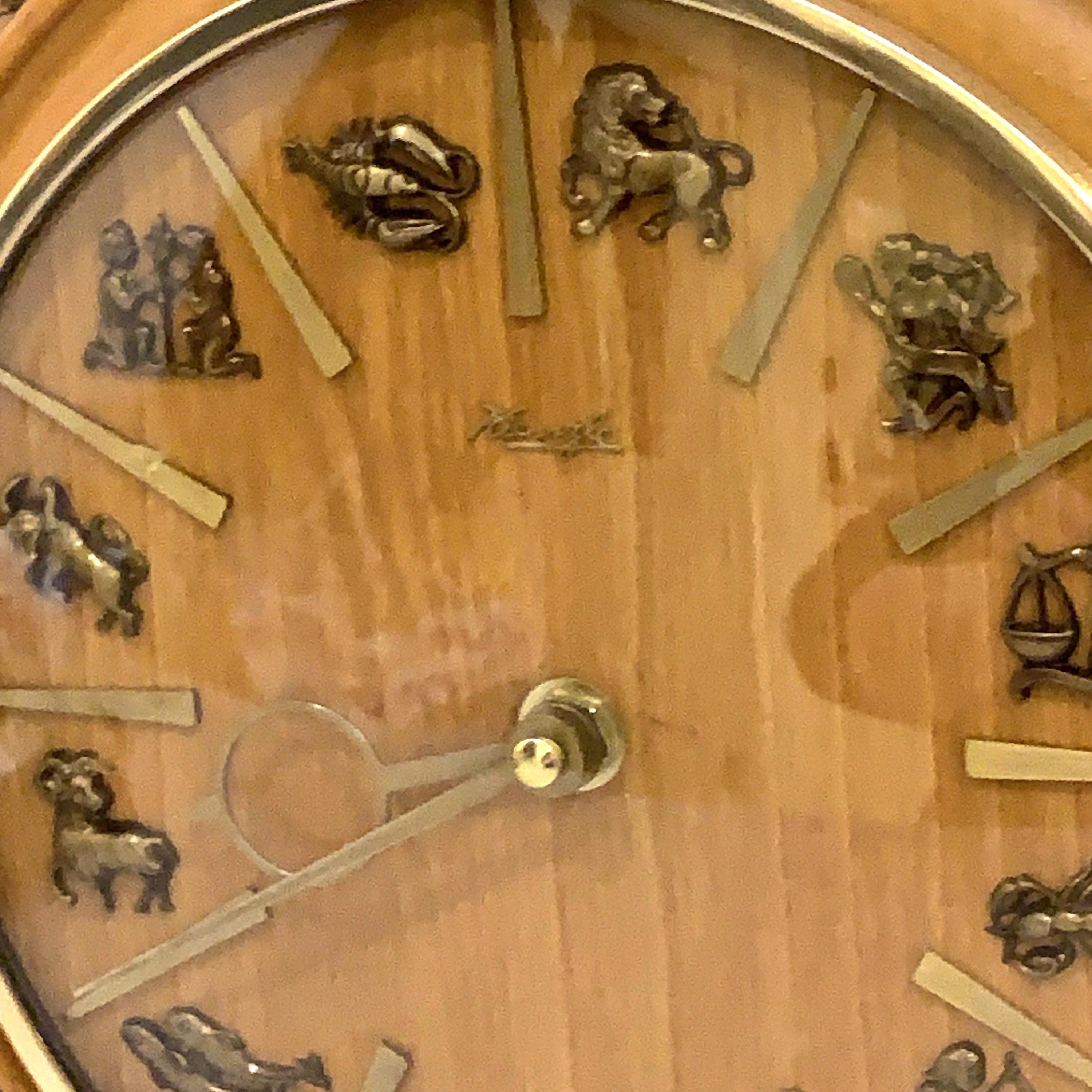 Kienzle Zodiac Wall Clock: Rope Hung Wooden Case, Brass Symbols, Mid Century 1960s Quartz
